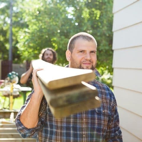 two men carrying equipment for glass repair and window replacement